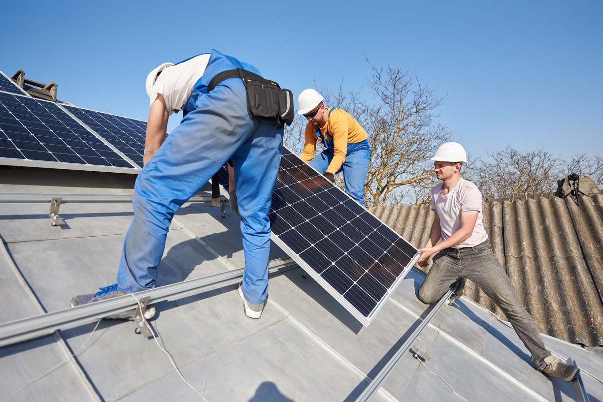 installing-solar-photovoltaic-panel-system-on-roof-2022-05-16-16-05-11-utc